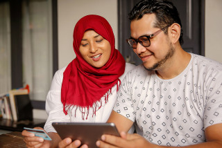 Couple making payment on tablet