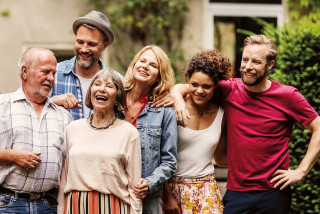 A family group standing together outdoors.