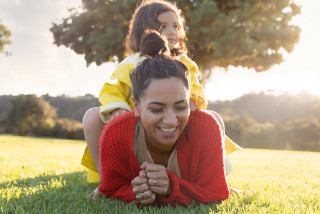 Mother and daughter smiling in the park