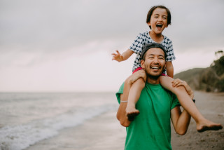 Father and child happy on beach together