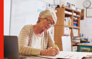 Older woman working at desk in office