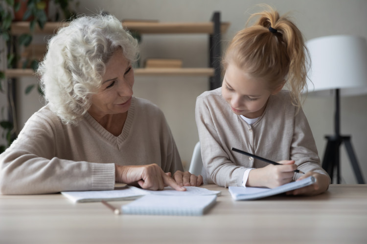 Older woman helping a child with homework